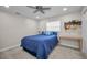 Bedroom featuring plush blue bedding, ceiling fan, and a stylish decor piece at 2486 Indian E Trl, Palm Harbor, FL 34683