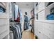 Organized walk-in closet with shelving, rods, and a full length mirror for ample storage at 2486 Indian E Trl, Palm Harbor, FL 34683