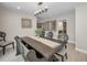 Charming dining room with wood table and bench seating, decorative chandelier, and neutral decor at 2486 Indian E Trl, Palm Harbor, FL 34683