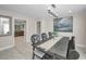 Elegant dining room with rustic wood table and chairs, chandelier, and a glimpse into the kitchen at 2486 Indian E Trl, Palm Harbor, FL 34683