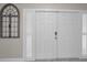 Elegant white front door featuring sidelights and an arched decorative window for added curb appeal at 2486 Indian E Trl, Palm Harbor, FL 34683