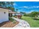 Inviting entrance with paver walkway, lush greenery, and a glimpse of the double doors at 2486 Indian E Trl, Palm Harbor, FL 34683