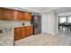 This kitchen has wood cabinets, stainless appliances, and granite countertops, offering a blend of style and functionality at 2486 Indian E Trl, Palm Harbor, FL 34683