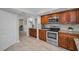 Functional kitchen showcasing wood cabinets, stainless steel appliances, and tiled backsplash at 2486 Indian E Trl, Palm Harbor, FL 34683