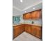 Bright kitchen featuring ample wood cabinetry, granite counters, and backyard views at 2486 Indian E Trl, Palm Harbor, FL 34683