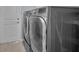 Modern laundry room featuring stainless steel washer and dryer units, showcasing convenience at 2486 Indian E Trl, Palm Harbor, FL 34683
