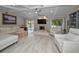 Bright living room featuring vaulted ceilings, a stone fireplace, and stylish furniture with access to the lanai at 2486 Indian E Trl, Palm Harbor, FL 34683