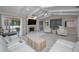 Spacious living room with a stone fireplace, white vaulted ceiling, and stylish white furniture at 2486 Indian E Trl, Palm Harbor, FL 34683