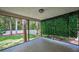 Large screened-in patio with lush greenery at 2486 Indian E Trl, Palm Harbor, FL 34683