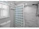 Modern bathroom shower featuring a pebble floor and marble subway tile walls at 2486 Indian E Trl, Palm Harbor, FL 34683