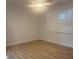 Bright bedroom with new flooring, large window, and shutter-style blinds at 24862 Us Highway 19 N # 2303, Clearwater, FL 33763
