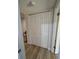 Hall closet with bi-fold doors and wood-look flooring at 24862 Us Highway 19 N # 2303, Clearwater, FL 33763
