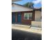 Charming condo exterior with brick facade, a small window, and twin bright blue doors at 24862 Us Highway 19 N # 2303, Clearwater, FL 33763