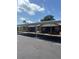 Apartment building with covered parking, showcasing brick facade and tidy landscaping on a bright day at 24862 Us Highway 19 N # 2303, Clearwater, FL 33763