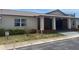 Community clubhouse exterior with brick accents, accessible entrance, and well-maintained landscaping at 24862 Us Highway 19 N # 2303, Clearwater, FL 33763