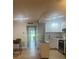 Stylish kitchen view showing white cabinets, stainless appliances, an island, and bar seating, open to the living area at 24862 Us Highway 19 N # 2303, Clearwater, FL 33763