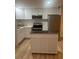 Modern kitchen featuring white cabinets, stainless steel appliances, and a functional center island at 24862 Us Highway 19 N # 2303, Clearwater, FL 33763