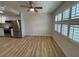 Living space with ceiling fan, shuttered windows, and view of the kitchen appliances at 24862 Us Highway 19 N # 2303, Clearwater, FL 33763