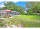 Expansive backyard with a pool, picnic table, and mature trees at 251 Dunbridge Dr, Palm Harbor, FL 34684