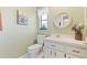 Charming bathroom with a quaint window, decorative mirror, and fresh, clean design at 251 Dunbridge Dr, Palm Harbor, FL 34684