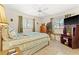 Cozy bedroom with ceiling fan, tile floors, two windows, and closet at 251 Dunbridge Dr, Palm Harbor, FL 34684