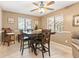 Dining area with high-top table, natural lighting, and adjacent breakfast bar at 251 Dunbridge Dr, Palm Harbor, FL 34684