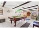 Spacious recreation room with pool table, tile flooring, dining area and wood beamed ceiling at 251 Dunbridge Dr, Palm Harbor, FL 34684