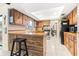 Galley kitchen with wood cabinets, a peninsula with seating and stainless steel appliances at 251 Dunbridge Dr, Palm Harbor, FL 34684
