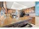 Traditional kitchen featuring wood cabinetry, stone countertops, and modern appliances at 251 Dunbridge Dr, Palm Harbor, FL 34684