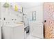 Functional laundry room with a washer, dryer, and overhead shelving at 251 Dunbridge Dr, Palm Harbor, FL 34684