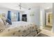 Comfortable main bedroom with a ceiling fan and easy access to the bathroom at 251 Dunbridge Dr, Palm Harbor, FL 34684