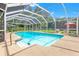 Sparkling screened-in pool with ample deck space and well-manicured landscaping at 251 Dunbridge Dr, Palm Harbor, FL 34684