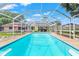 Enjoy the sparkling pool inside a screened enclosure surrounded by lush landscaping at 251 Dunbridge Dr, Palm Harbor, FL 34684