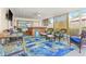 Relaxing sunroom with wicker furniture, pineapple patterned rugs and a hot tub at 251 Dunbridge Dr, Palm Harbor, FL 34684