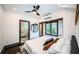 Comfortable bedroom with ceiling fan, hardwood floors, ample natural light, and ensuite bathroom at 2536 Burlington N Ave, St Petersburg, FL 33713