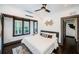 Cozy bedroom with large window, ceiling fan, hardwood floors and stylish decor at 2536 Burlington N Ave, St Petersburg, FL 33713