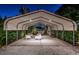 Covered carport area with seating, framed by lush greenery and decorative lighting at 2536 Burlington N Ave, St Petersburg, FL 33713