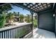 Daytime view of a charming courtyard with pergola, lush greenery, and inviting walkway at 2536 Burlington N Ave, St Petersburg, FL 33713