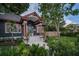 Beautiful home showcasing a well-maintained lawn, garden, and charming front porch with copper pillars at 2536 Burlington N Ave, St Petersburg, FL 33713