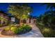 Charming home exterior at twilight, showcasing a well-lit pathway and landscaped garden at 2536 Burlington N Ave, St Petersburg, FL 33713