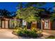 Charming home exterior at twilight, showcasing a well-lit pathway and landscaped garden at 2536 Burlington N Ave, St Petersburg, FL 33713