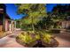 Charming home exterior at twilight, showcasing a well-lit pathway and landscaped garden at 2536 Burlington N Ave, St Petersburg, FL 33713