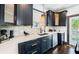 Sleek kitchen with dark cabinets, quartz countertops, stylish backsplash, and stainless steel appliances at 2536 Burlington N Ave, St Petersburg, FL 33713
