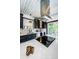 Kitchen with modern island cooktop, stainless steel appliances, quartz countertops and dark cabinets at 2536 Burlington N Ave, St Petersburg, FL 33713