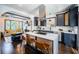 Open concept kitchen with island seating, stainless steel appliances, dark cabinets, and hardwood floors at 2536 Burlington N Ave, St Petersburg, FL 33713