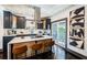 Kitchen with island seating, stainless steel appliances, dark cabinets, and outside view at 2536 Burlington N Ave, St Petersburg, FL 33713