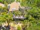 Aerial view of a home featuring a large wooden deck surrounded by lush tropical landscaping at 2613 59Th S St, Gulfport, FL 33707
