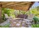 Cozy backyard patio with a swing, rocking chairs, and serene landscaping at 2613 59Th S St, Gulfport, FL 33707