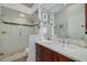 Modern bathroom featuring glass enclosed shower, and vanity with dark wood cabinets at 2613 59Th S St, Gulfport, FL 33707