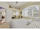 Bedroom features a large window, ceiling fan, and a doorway that provides a view into another room at 2613 59Th S St, Gulfport, FL 33707